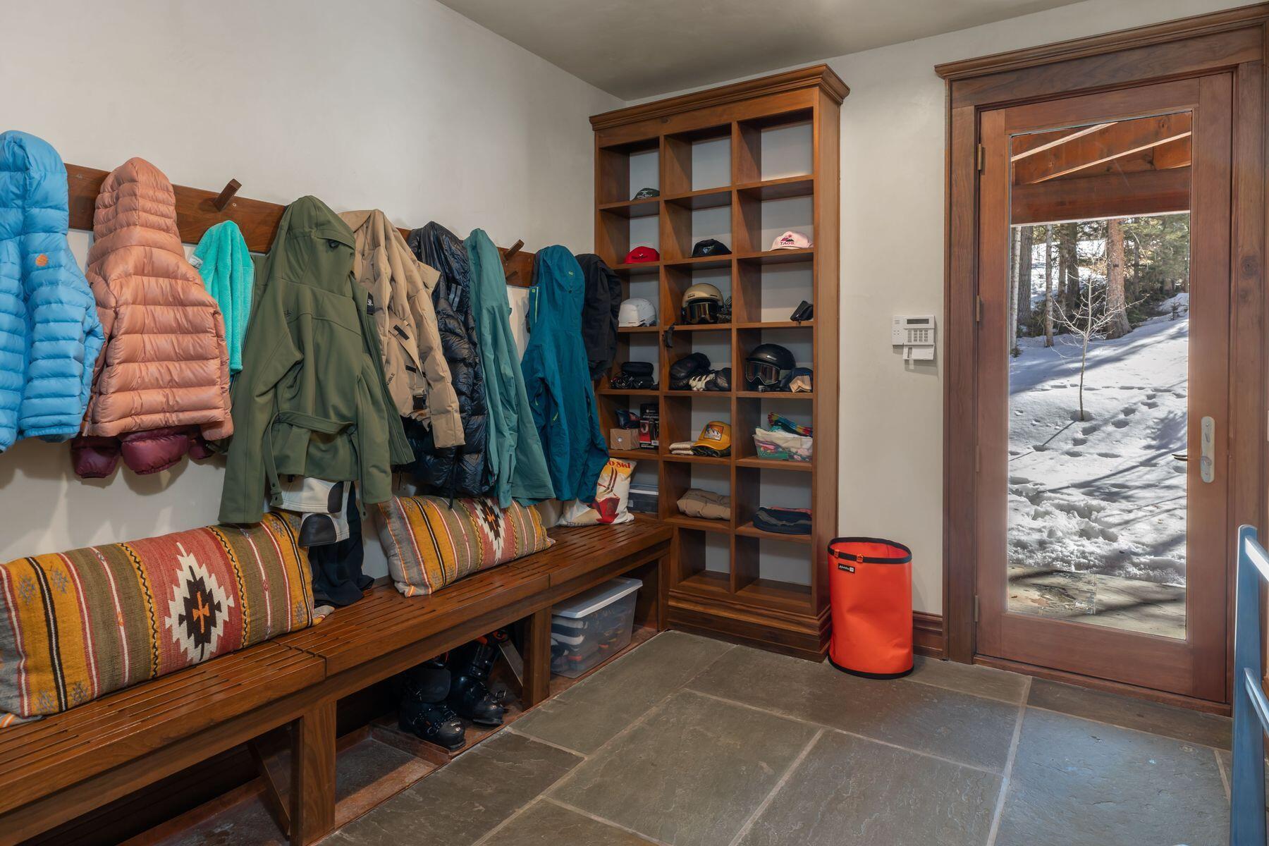 222 High Country Road Mountain Village, CO 81435 - Photo 27 of 37 a living room with furniture a rug and a book shelf