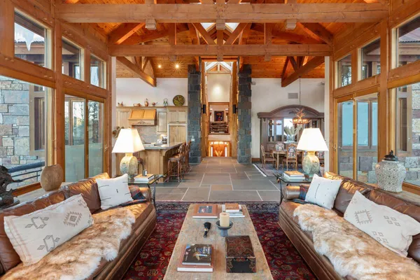 a living room with furniture and a floor to ceiling window