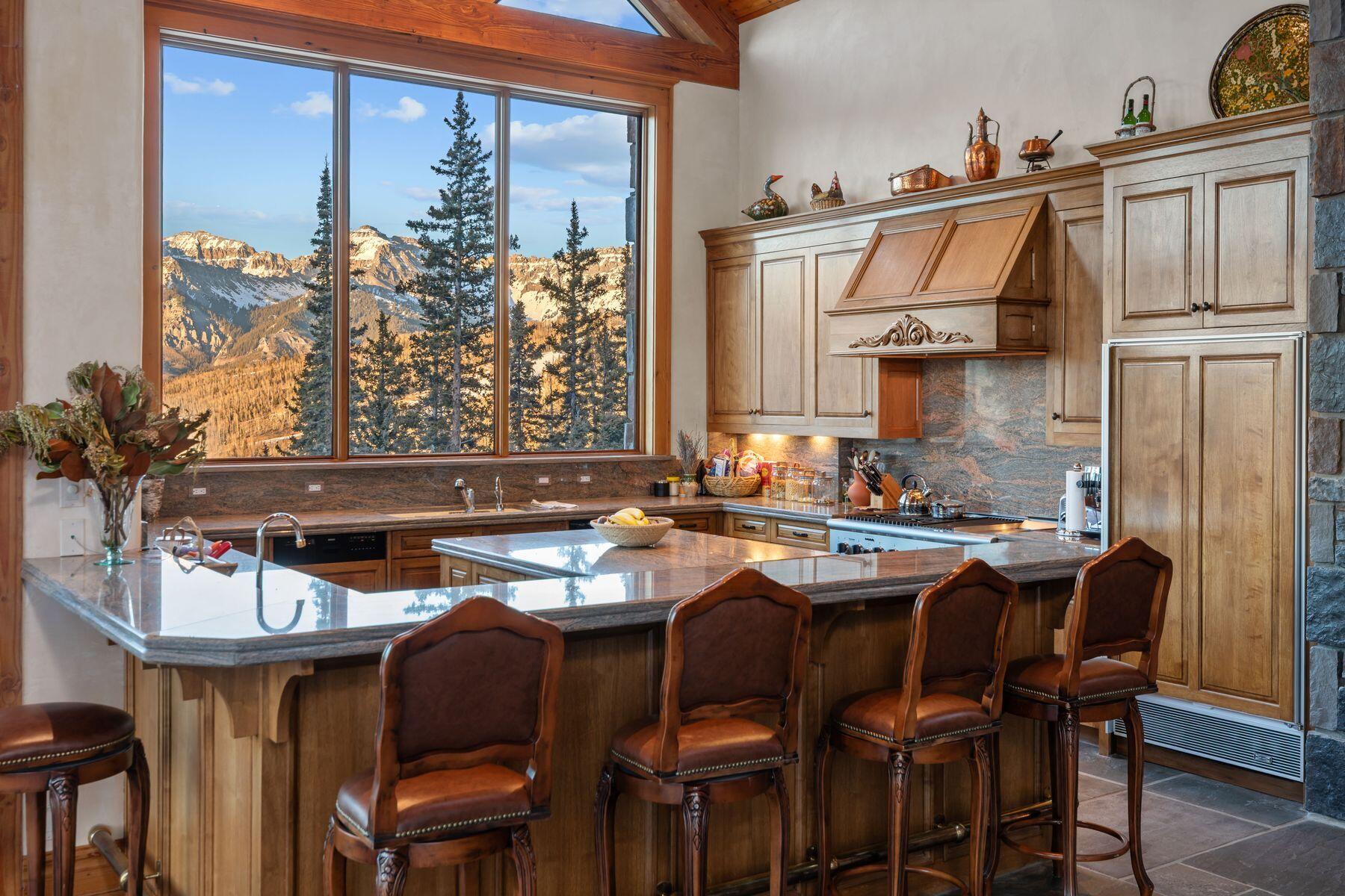 222 High Country Road Mountain Village, CO 81435 - Photo 8 of 37 a kitchen with stainless steel appliances a table and chairs in it