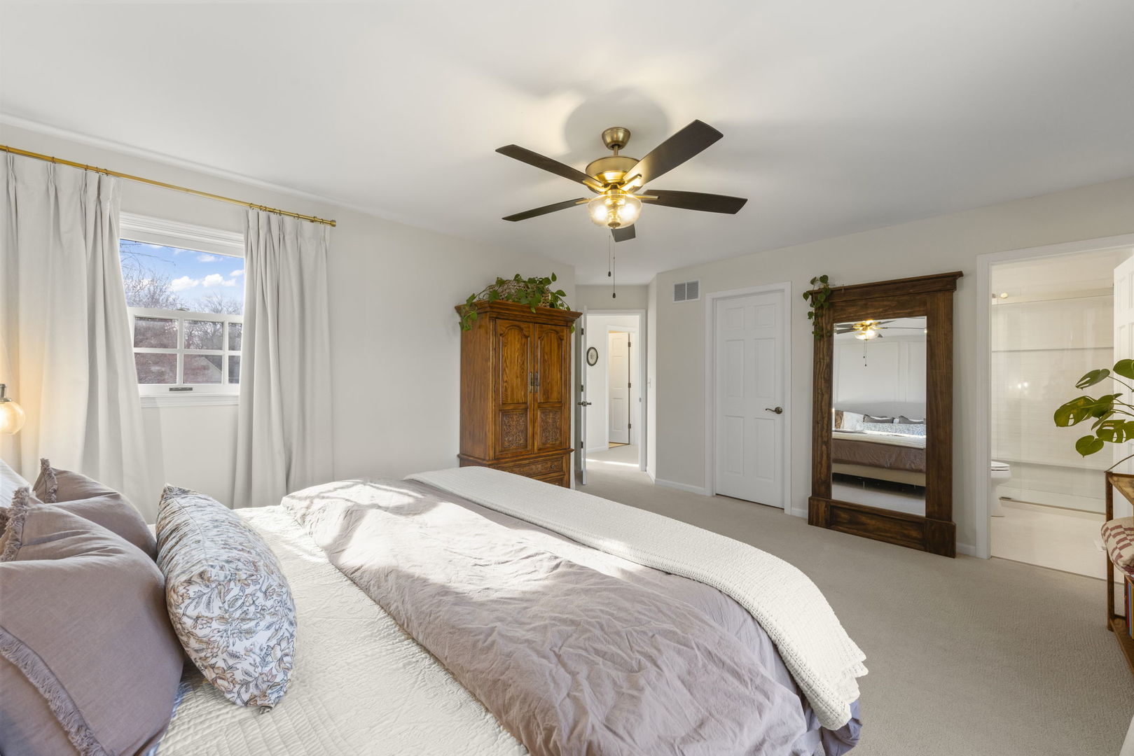 19 Shagbark Lane Newark, IL 60541 - Photo 20 of 60 a bedroom with a large bed and a chandelier