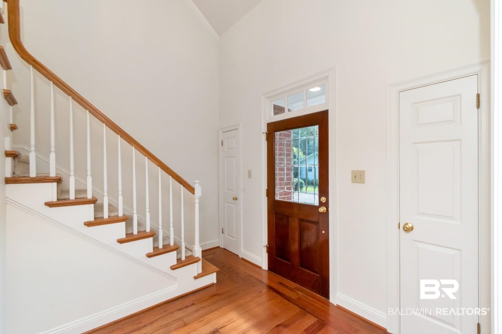 105 McHugh Lane Mobile, AL 36608 - Photo 17 of 30 Foyer with hardwood / wood-style flooring, a towering ceiling, and stairway