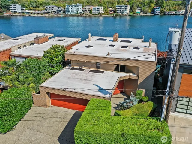an aerial view of a house with table and chairs