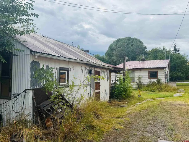 a view of a chair and table in backyard