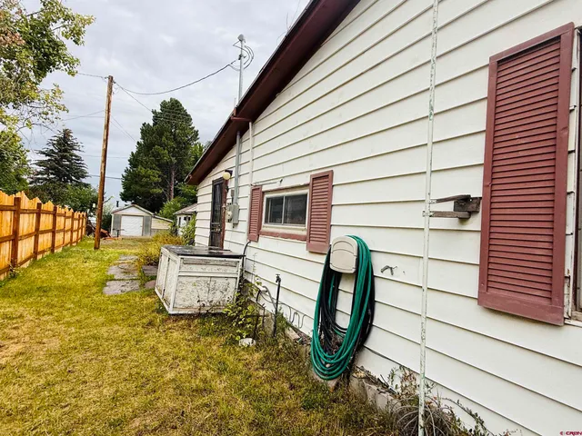 a view of a white house with a yard