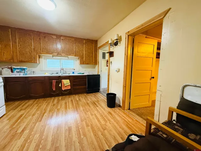 a view of kitchen with wooden floor and electronic appliances