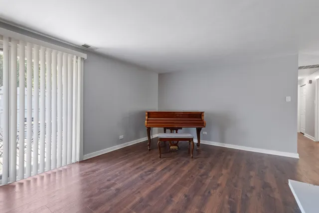 a room with wooden floor and furniture