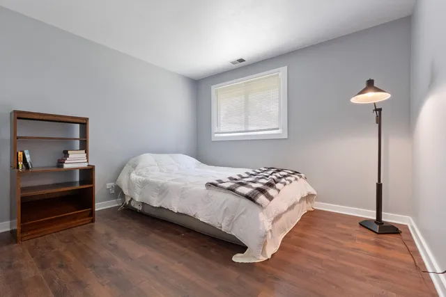 a bedroom with a bed and a lamp