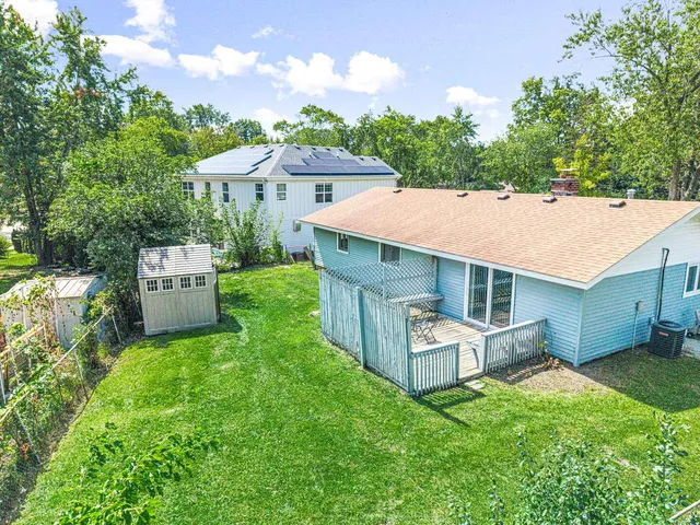 an aerial view of a house with a garden and swimming pool