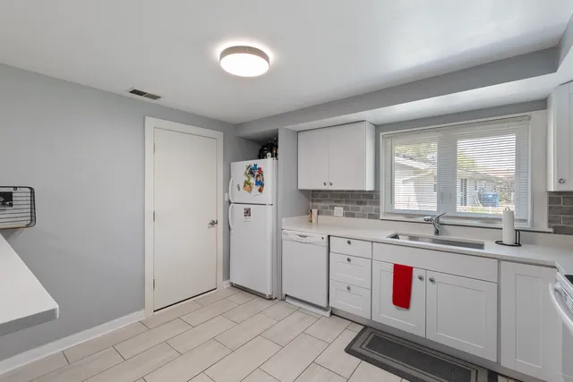 a kitchen with sink cabinets and window