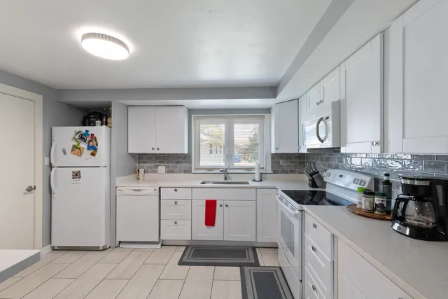 a kitchen with a sink stove and cabinets