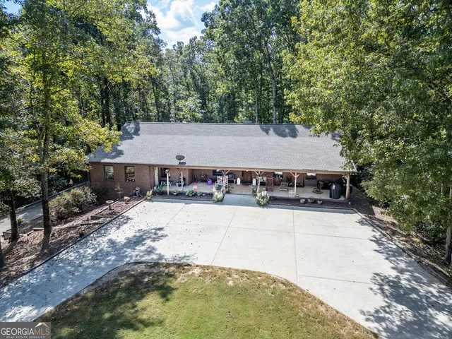 a view of a house with pool and yard