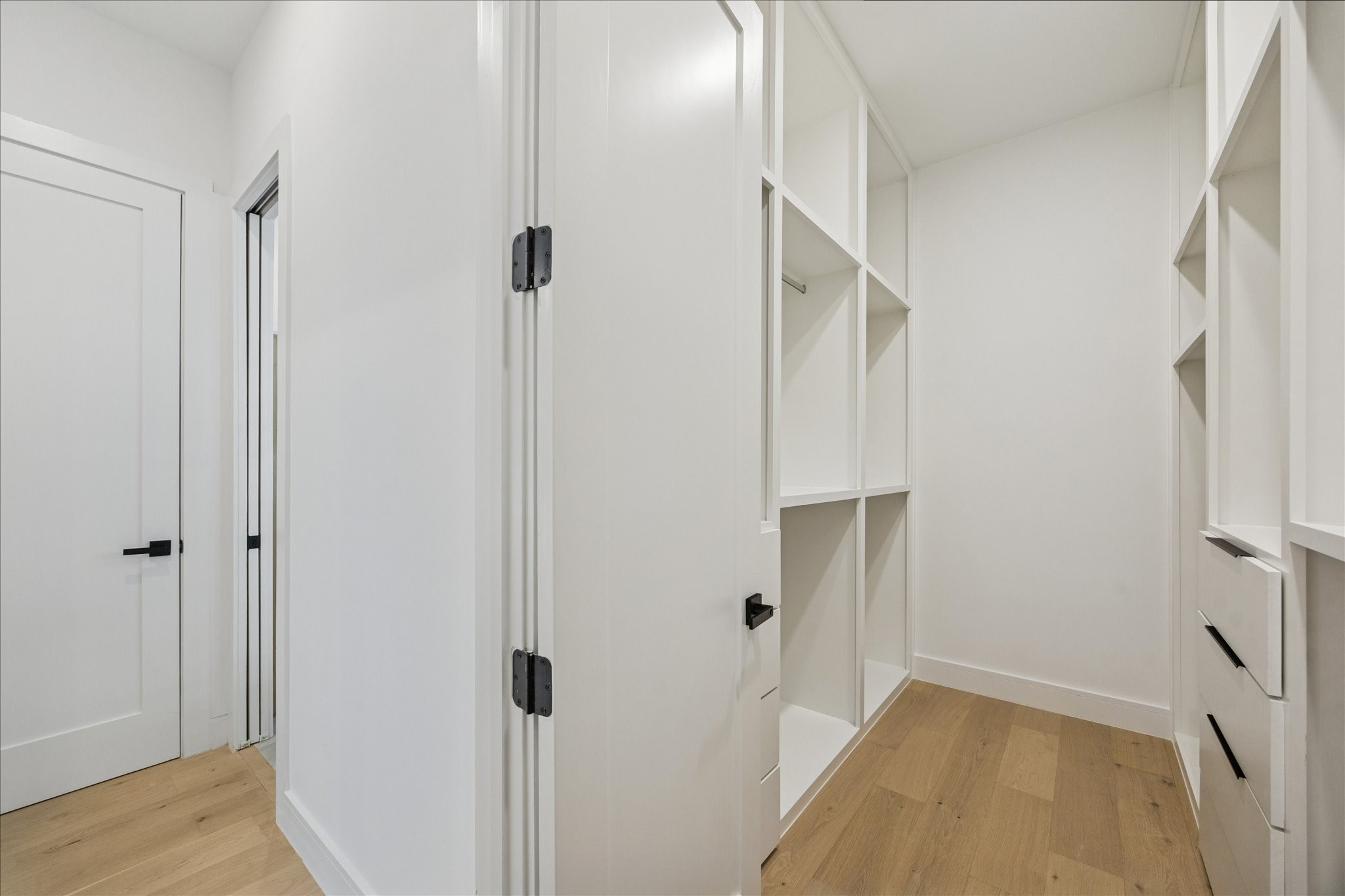 809 Memorial Heights Drive Houston, TX 77007 - Photo 23 of 32 Custom primary walk-in closet featuring extensive built-in shelving, hanging space, and integrated drawer storage for effortless organization.