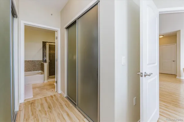 a bathroom with a granite countertop sink a mirror and a bathtub