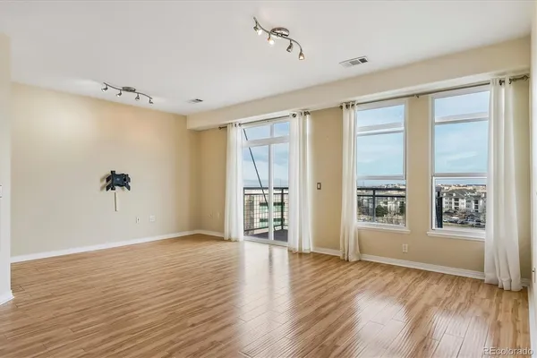 a view of a room with wooden floor and a bathroom