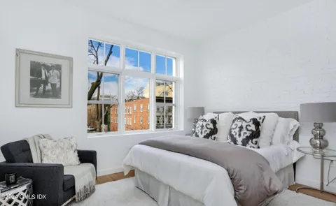 a bedroom with a bed and a couch