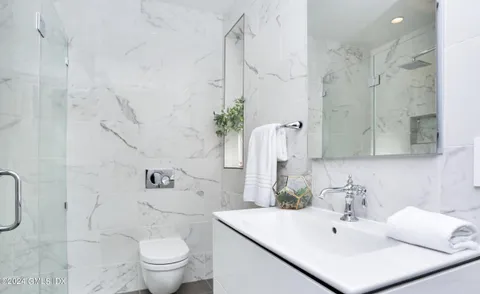 a bathroom with a sink toilet and shower