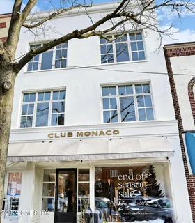 a view of a building with glass windows and a street