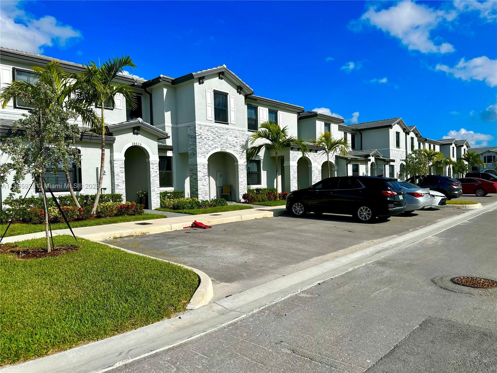 28661 Southwest 132nd Place Homestead, FL 33033 - Photo 1 of 22 a front view of a house with a yard
