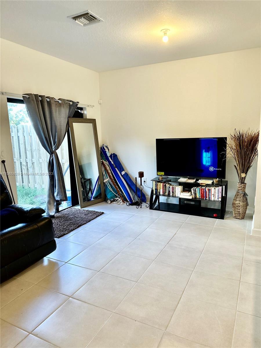 28661 Southwest 132nd Place Homestead, FL 33033 - Photo 7 of 22 a living room with furniture and a flat screen tv