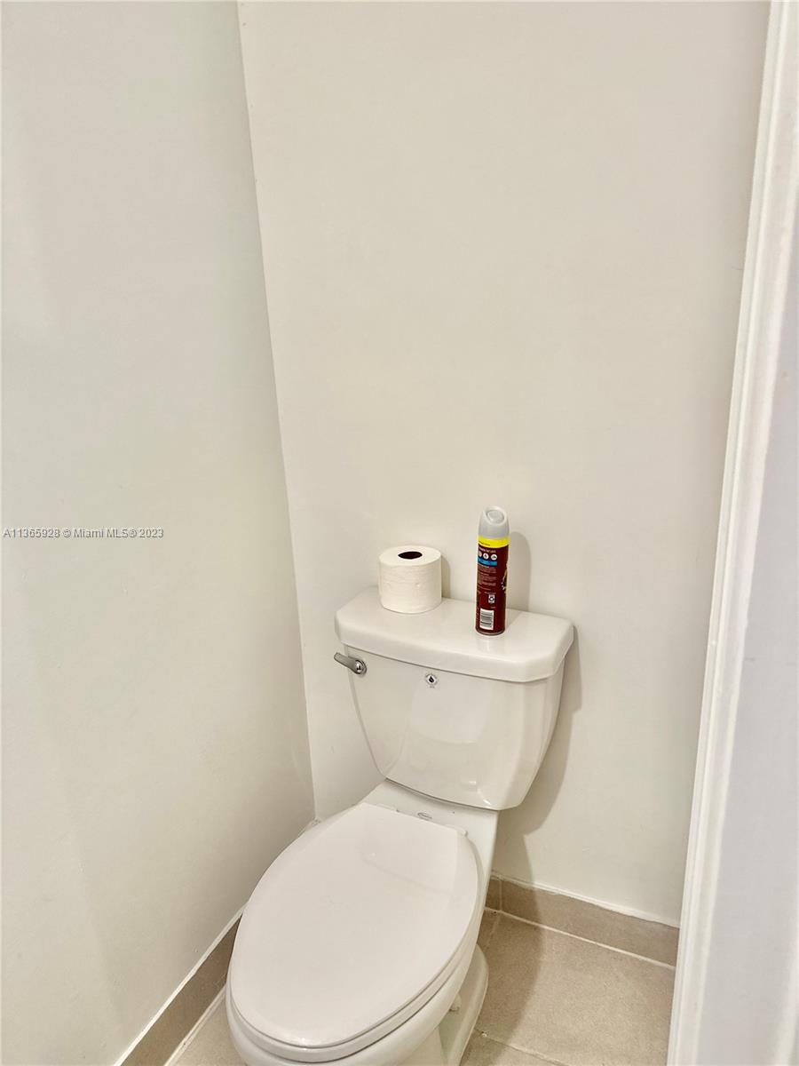 28661 Southwest 132nd Place Homestead, FL 33033 - Photo 10 of 22 a white toilet sitting next to a white sink and vanity