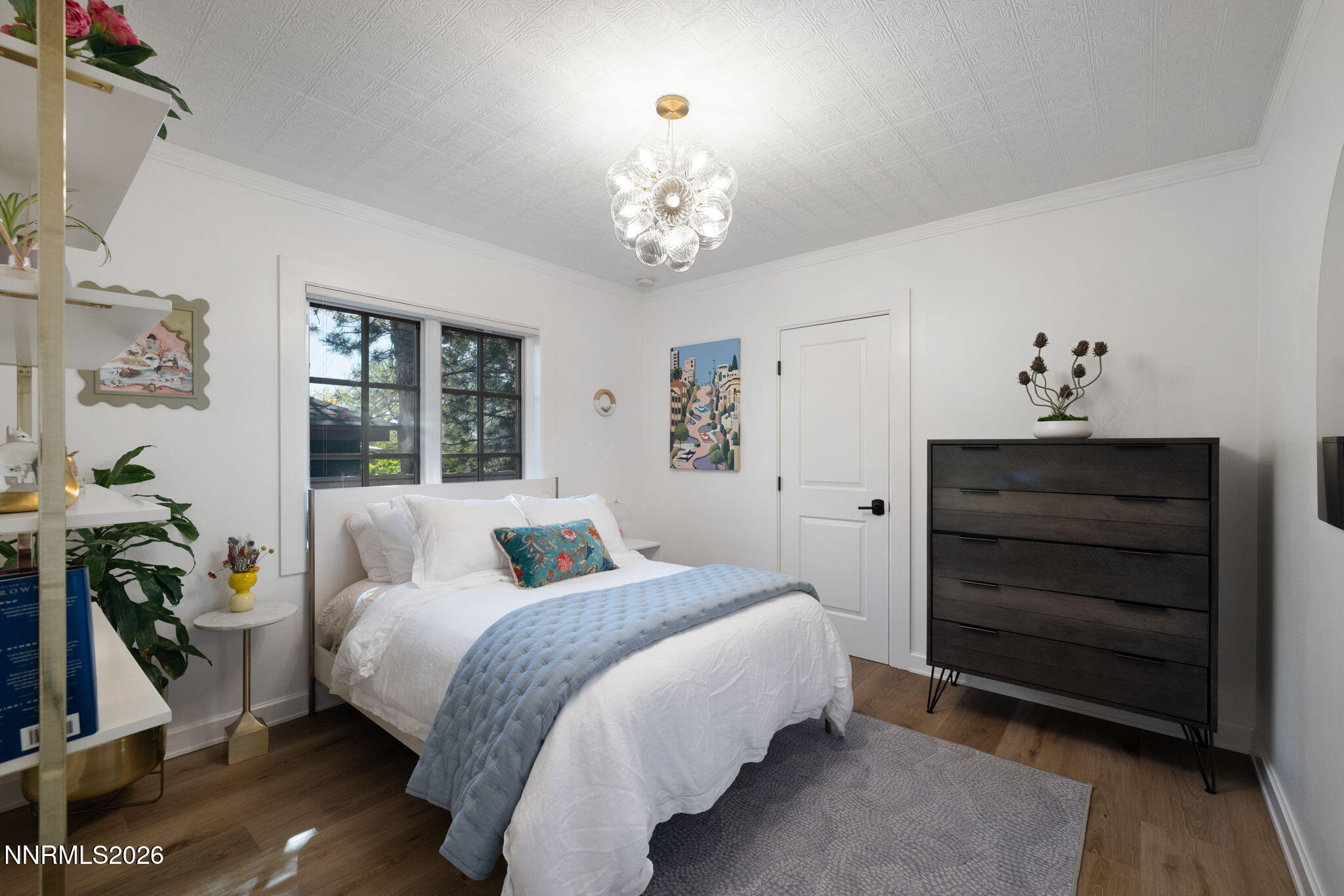 210 Bret Harte Avenue Reno, NV 89509 - Photo 24 of 40 a bedroom with a bed and a chandelier