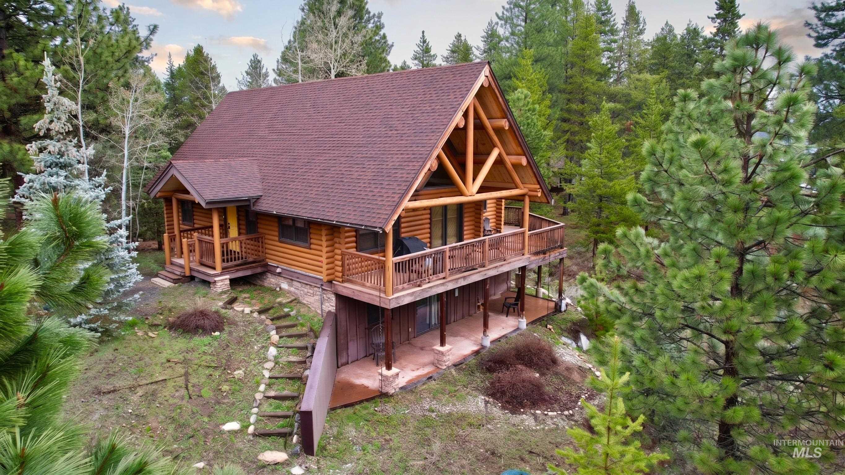 Log cabin residence featuring a prominent gabled roofline and exposed timber framing