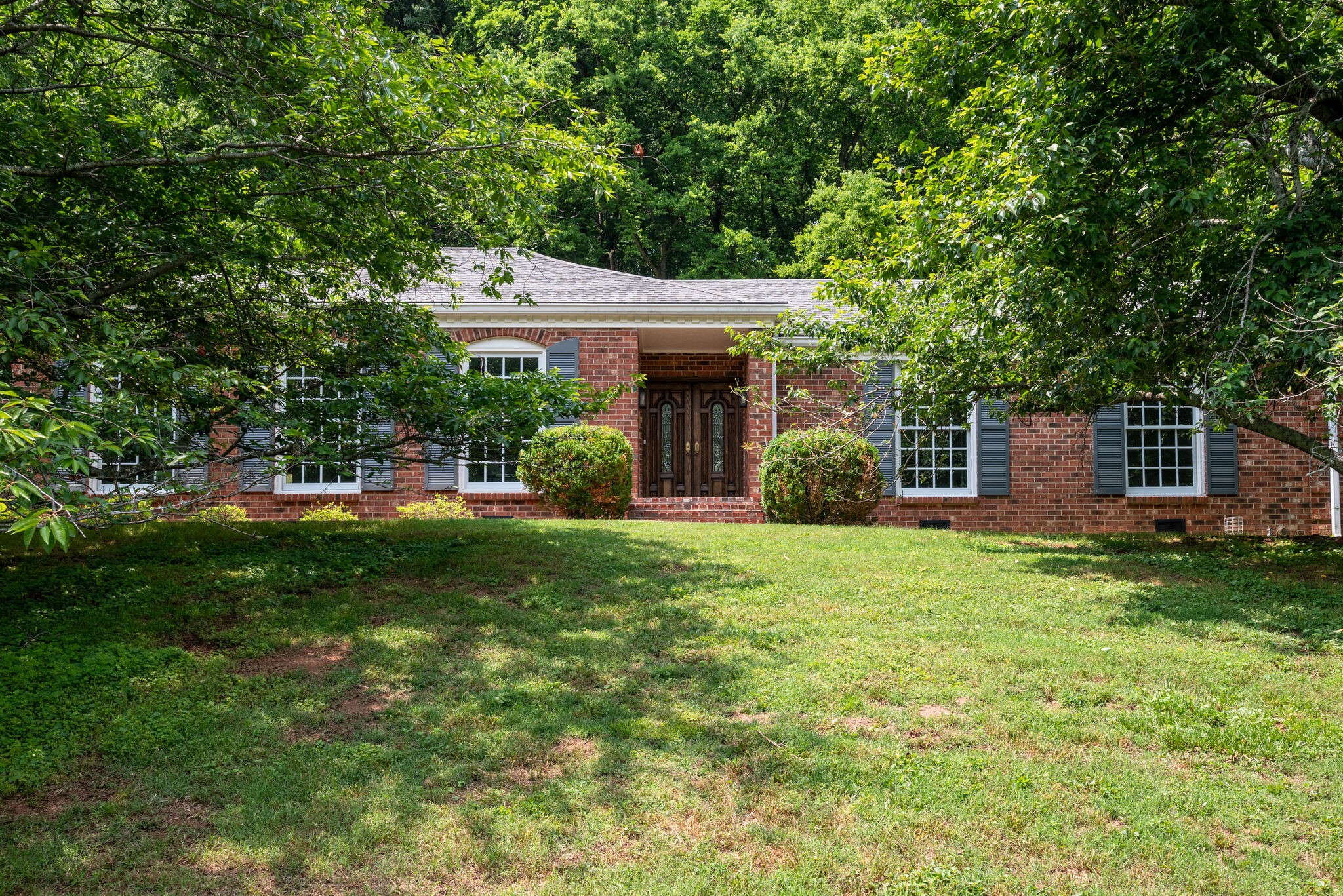 6612 Ellesmere Road Nashville, TN 37205 - Photo 1 of 34 a front view of a house with a garden