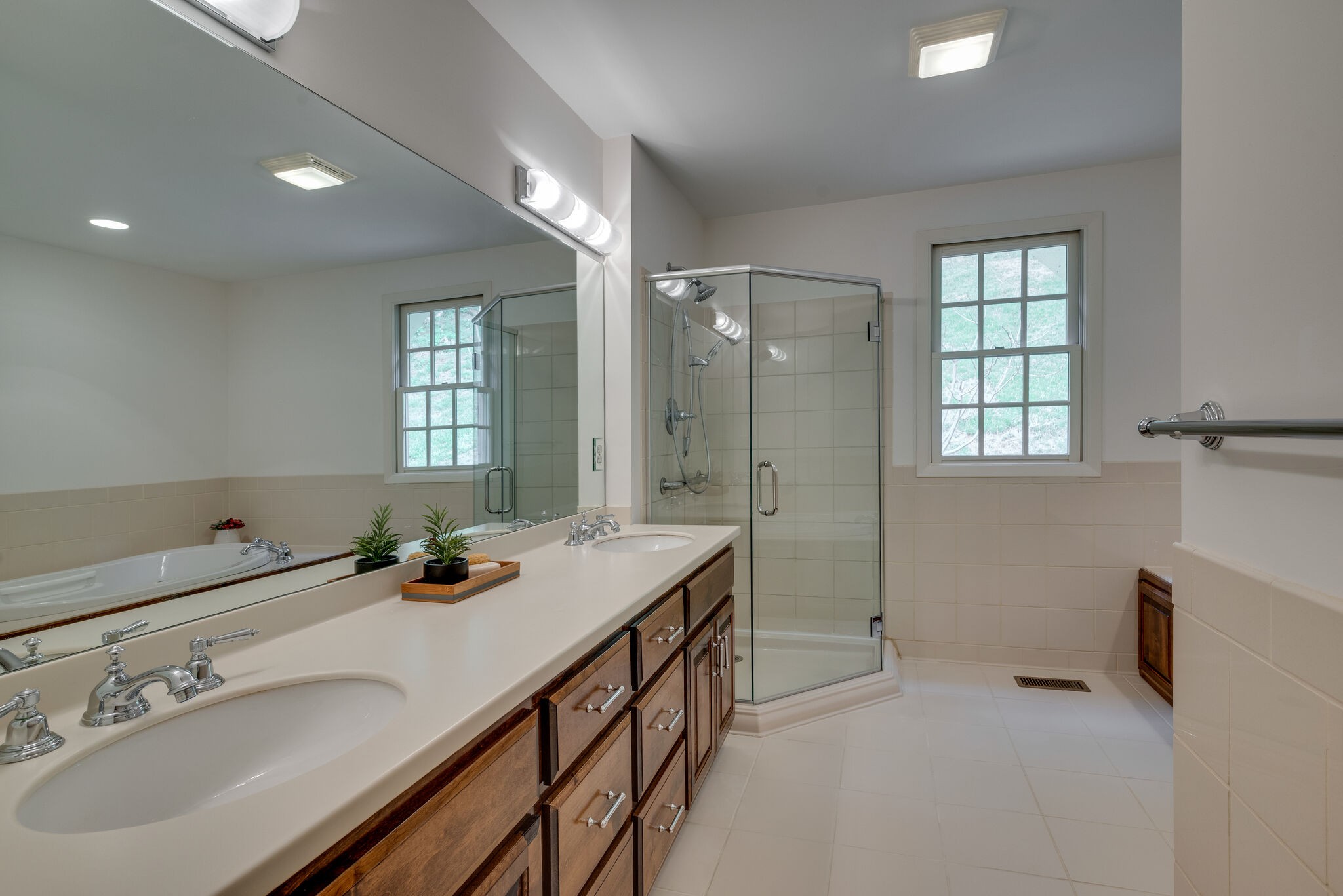 6612 Ellesmere Road Nashville, TN 37205 - Photo 20 of 34 a bathroom with a double vanity sink a mirror and a shower