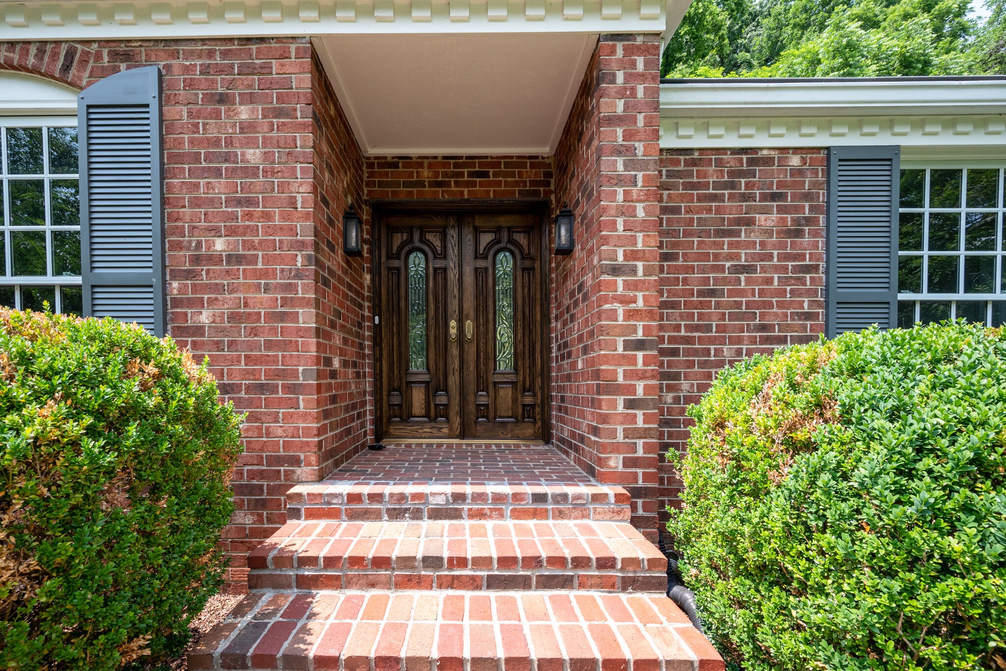 6612 Ellesmere Road Nashville, TN 37205 - Photo 2 of 34 a view of a brick house with plants