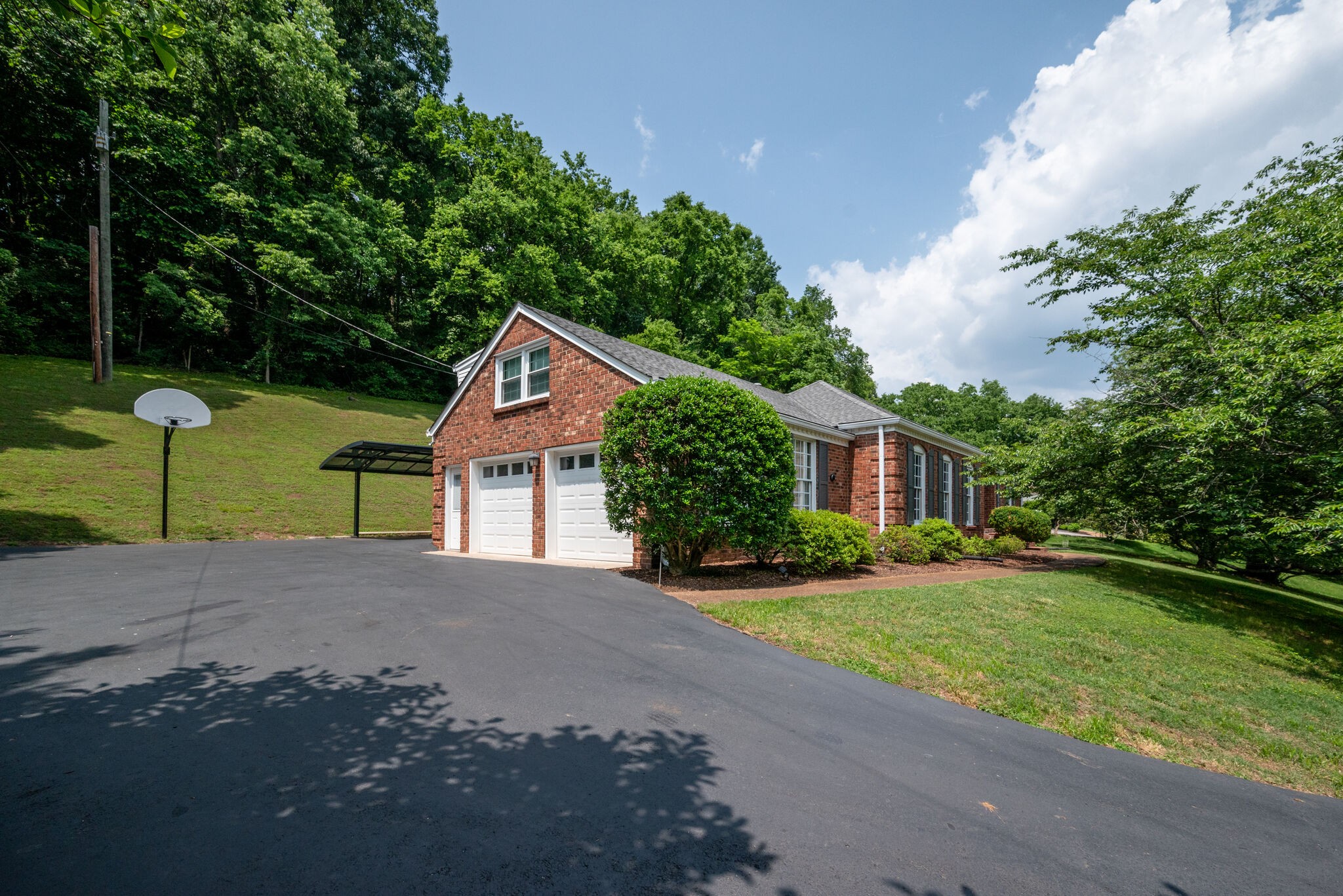 6612 Ellesmere Road Nashville, TN 37205 - Photo 33 of 34 a front view of a house with a yard and garage