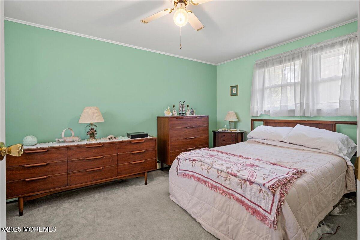 418 Salem Avenue Spring Lake, NJ 07762 - Photo 15 of 29 a bedroom with a bed and a chandelier
