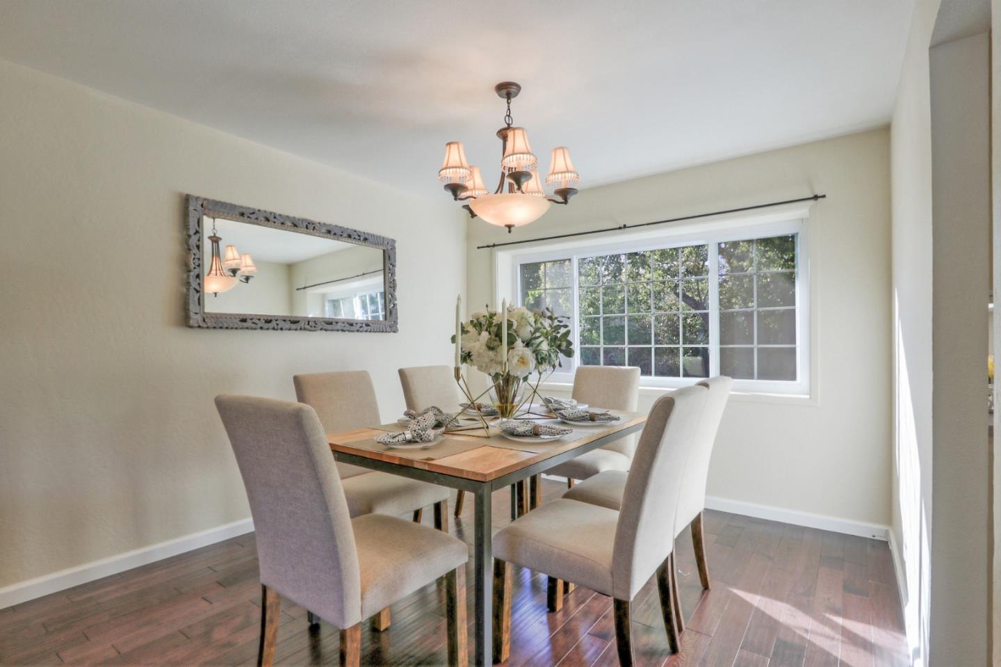 2250 Yosemite Drive Milpitas, CA 95035 - Photo 18 of 43 a dining room with furniture a window and a chandelier