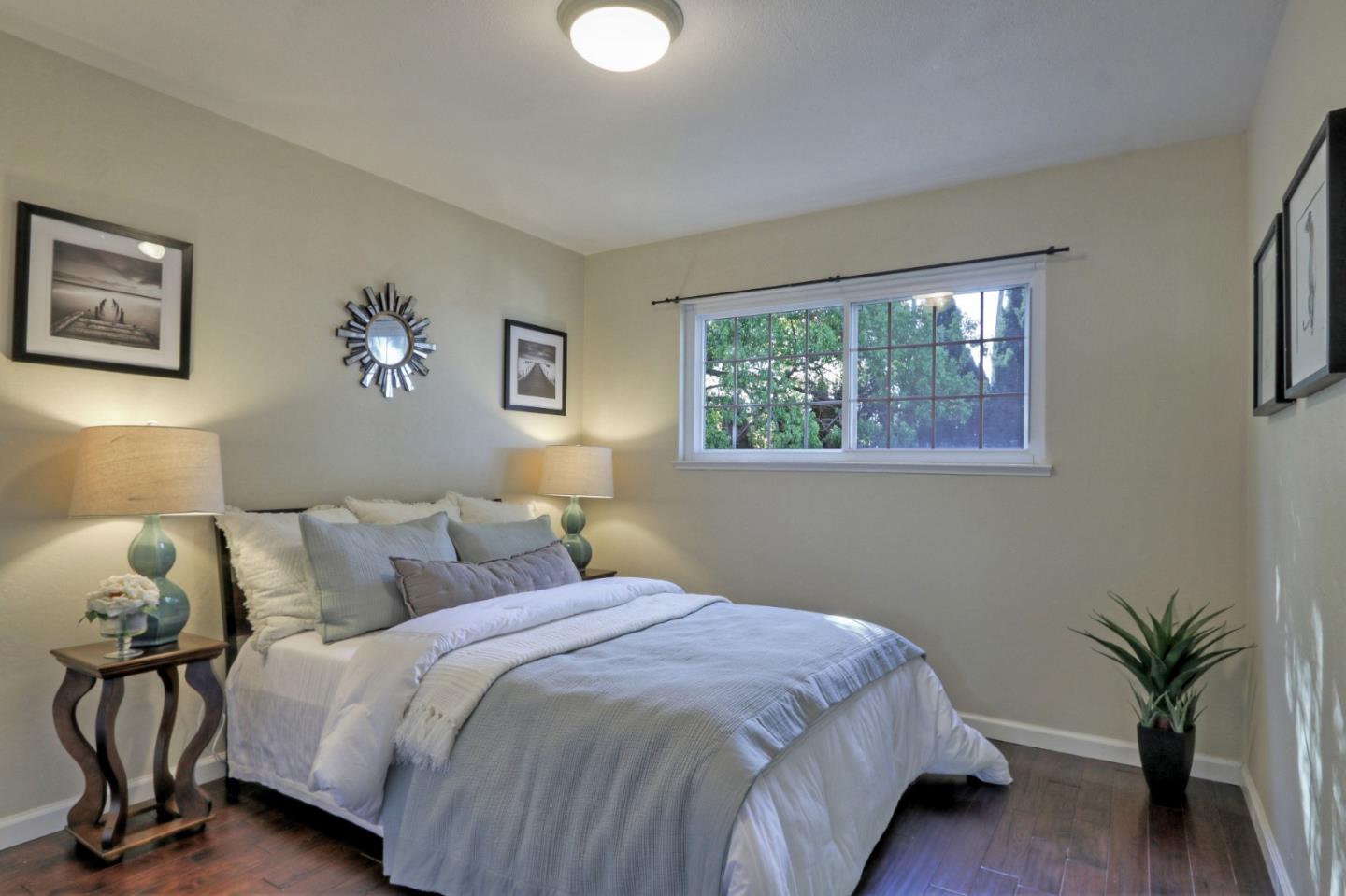 2250 Yosemite Drive Milpitas, CA 95035 - Photo 23 of 43 a bedroom with a bed and a potted plant