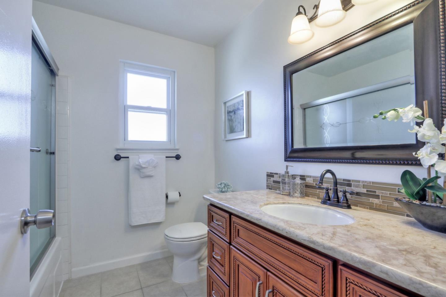 2250 Yosemite Drive Milpitas, CA 95035 - Photo 25 of 43 a bathroom with a granite countertop sink a toilet and a mirror