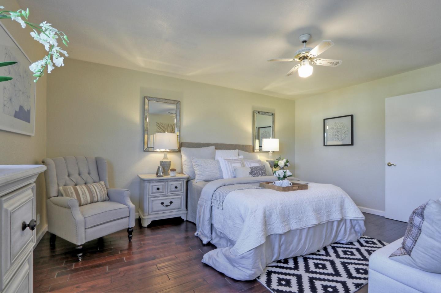 2250 Yosemite Drive Milpitas, CA 95035 - Photo 28 of 43 a bedroom with a bed and a chandelier