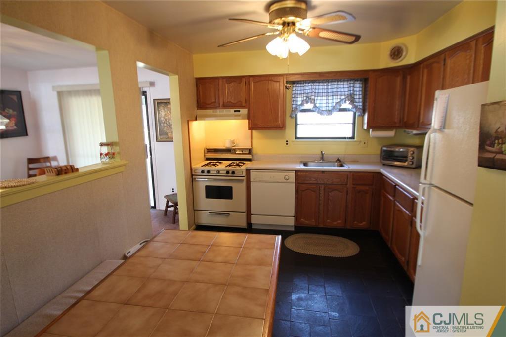6605 Hana Road Edison, NJ 08817 - Photo 4 of 17 a kitchen with stainless steel appliances a stove a refrigerator and a sink