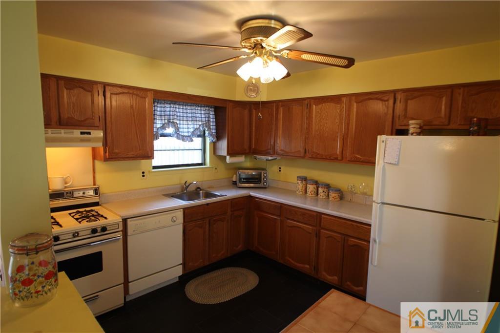 6605 Hana Road Edison, NJ 08817 - Photo 5 of 17 a kitchen with a sink appliances and cabinets