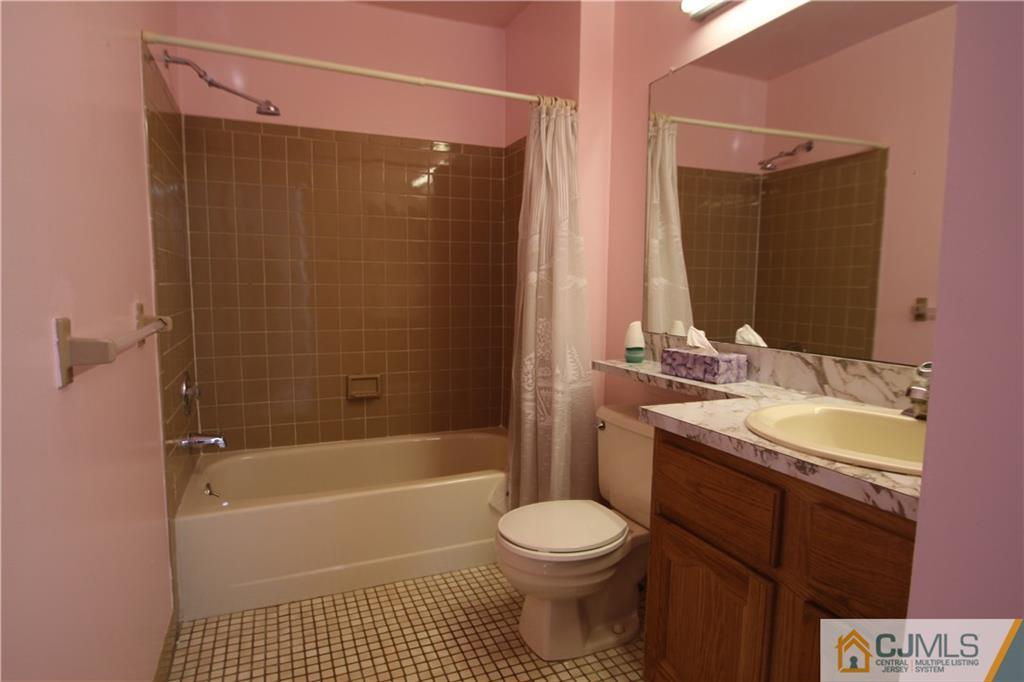 6605 Hana Road Edison, NJ 08817 - Photo 7 of 17 a bathroom with a sink a toilet and a bathtub