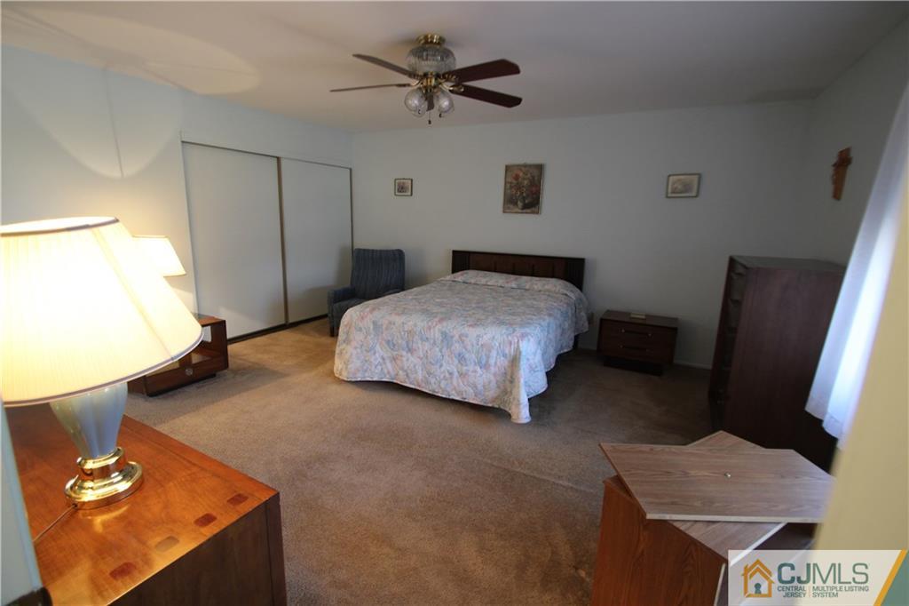 6605 Hana Road Edison, NJ 08817 - Photo 9 of 17 a bedroom with a bed and a flat screen tv