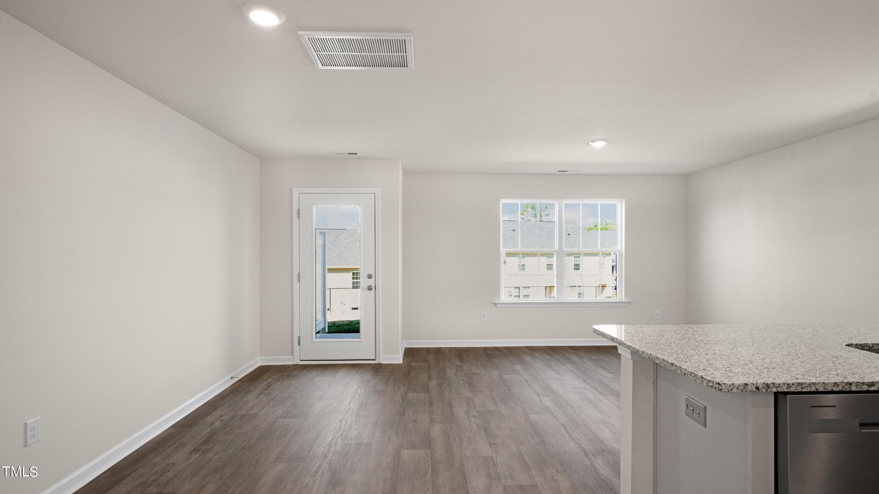 3202 Alibird Lane Carthage, NC 28327 - Photo 13 of 33 an empty room with wooden floor and windows