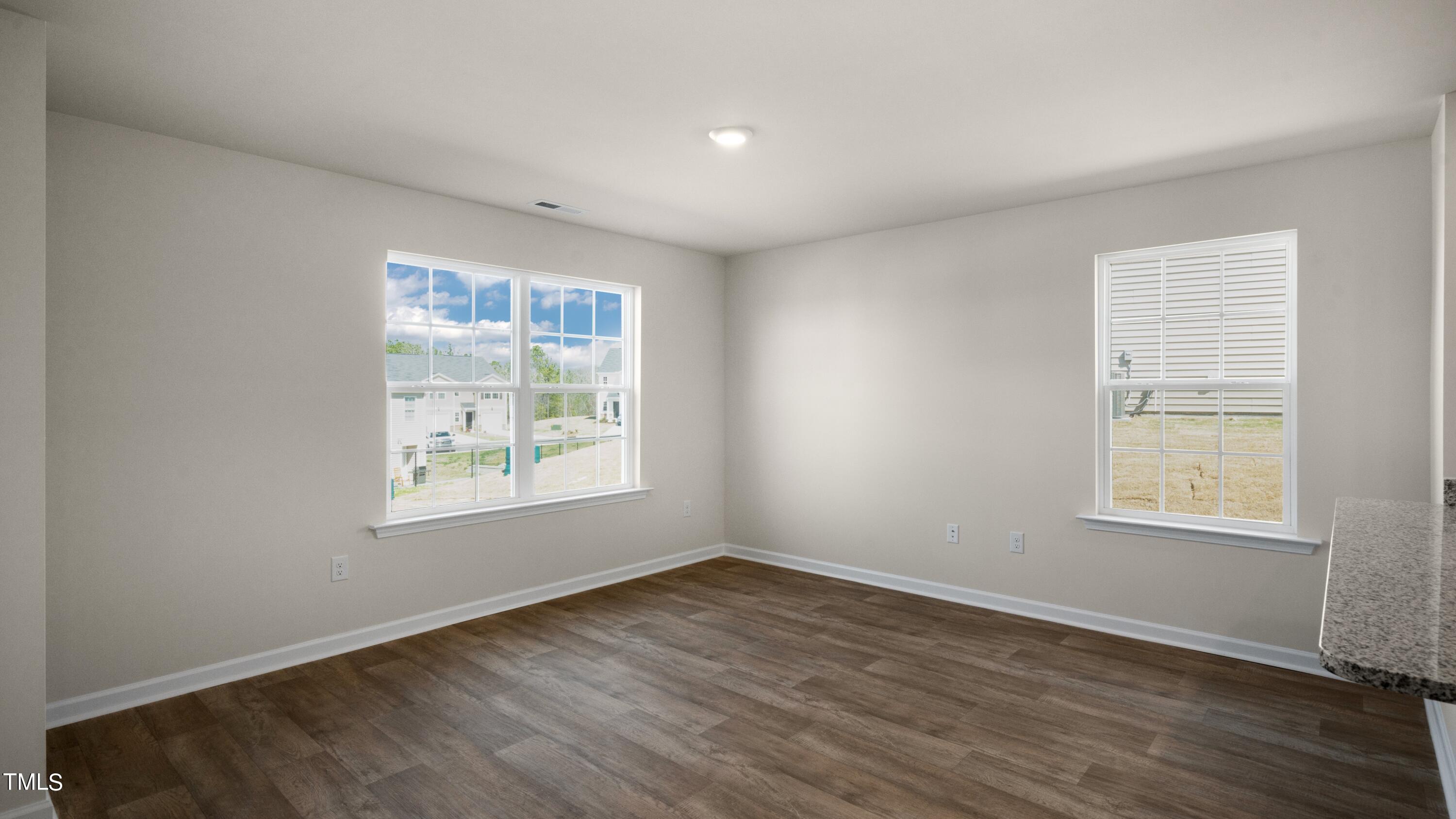 3202 Alibird Lane Carthage, NC 28327 - Photo 16 of 33 an empty room with wooden floor and windows
