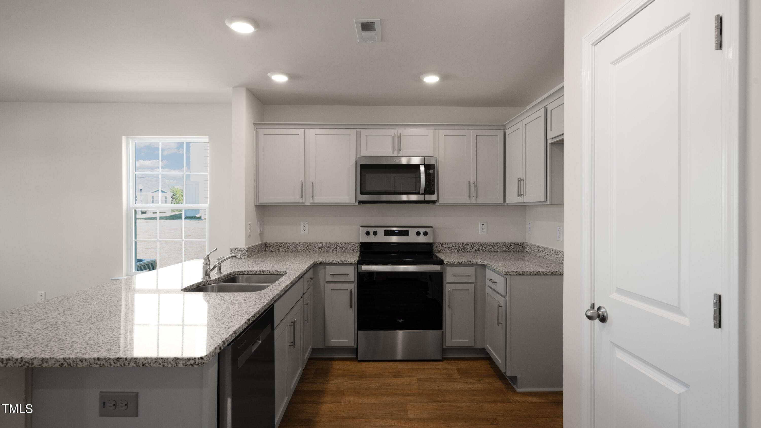 3202 Alibird Lane Carthage, NC 28327 - Photo 4 of 33 a kitchen with a stove and a microwave