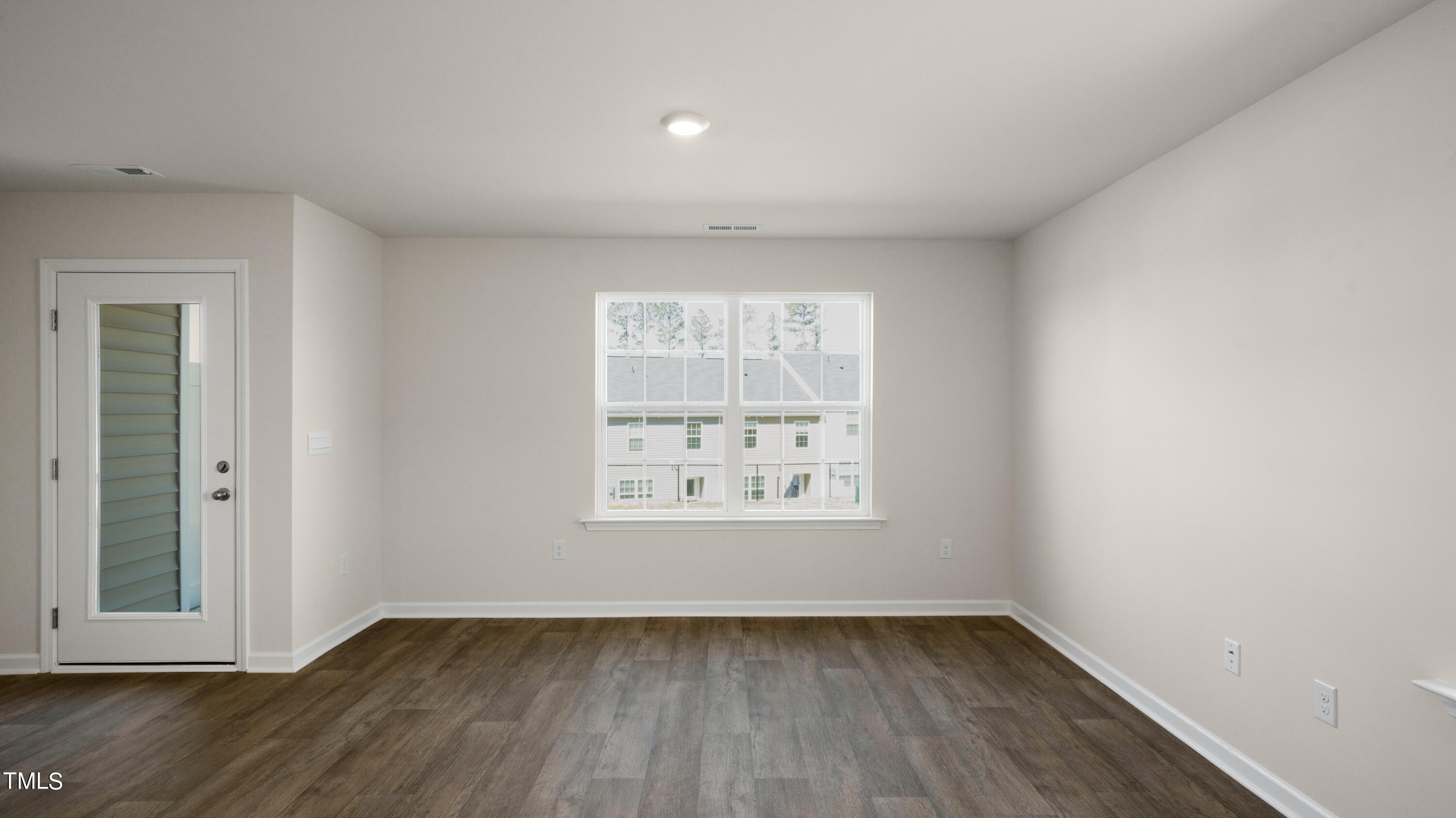 3202 Alibird Lane Carthage, NC 28327 - Photo 6 of 33 an empty room with wooden floor and windows
