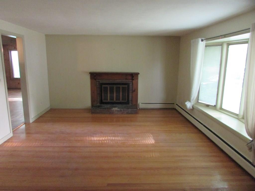 33 Irene Street Springfield, MA 01108 - Photo 15 of 35 a view of an empty room with a fireplace and a window