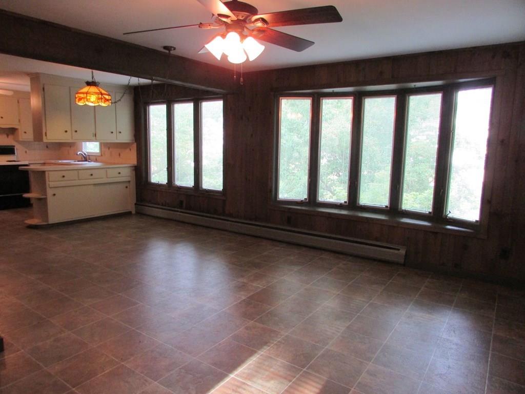 33 Irene Street Springfield, MA 01108 - Photo 3 of 35 a view of an empty room with a window and wooden floor