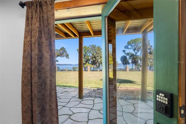 a view of a patio with table and chairs under an umbrella