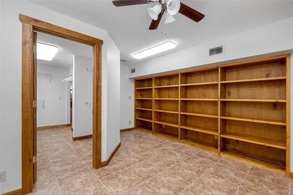 a view of a backyard with a garden and outdoor seating