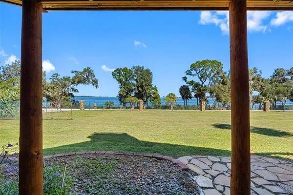 a view of a lake with a yard and mountain view