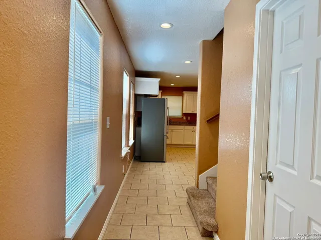 a view of a hallway with a kitchen