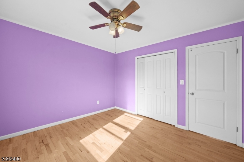 136 Clifton Boulevard Clifton, NJ 07011 - Photo 16 of 16 a view of a big room with wooden floor and a ceiling fan